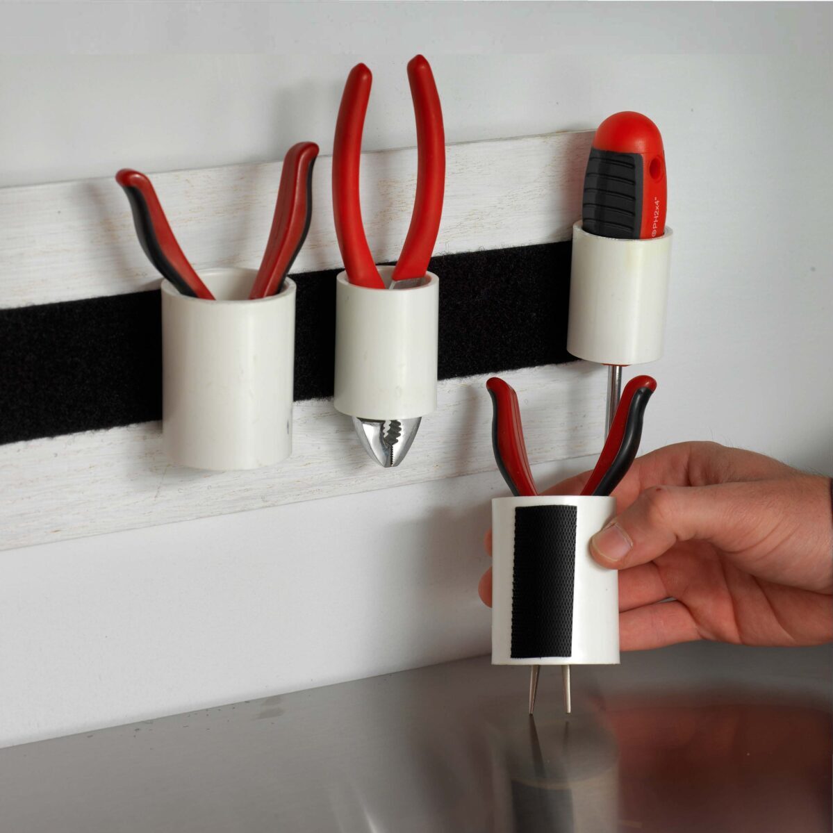 VELCRO Heavy Duty Stick On Tape being used to stick tools to wall